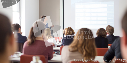 Image of Woman giving presentation in lecture hall at university.