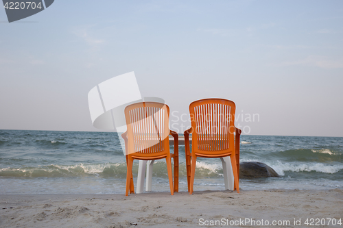 Image of Two sun loungers on seashore