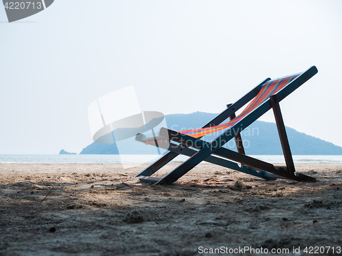 Image of Deck chair on sandy beach