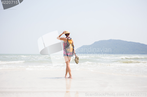 Image of Young girl in hat on seashore