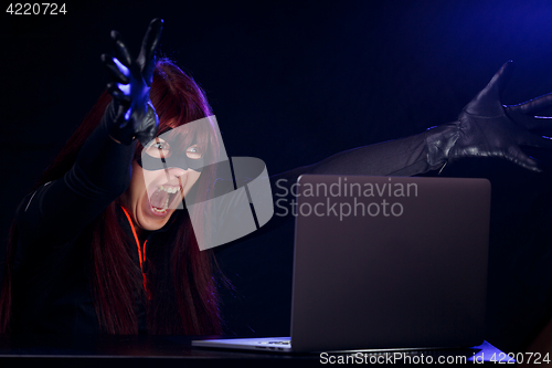 Image of Young woman hacker at night