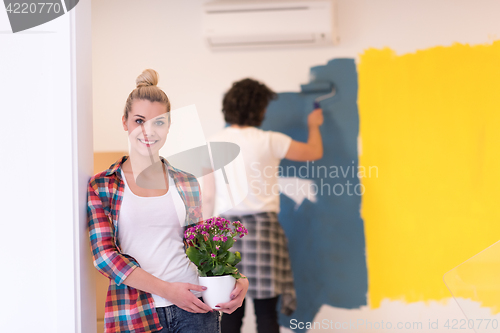 Image of happy young couple doing home renovations