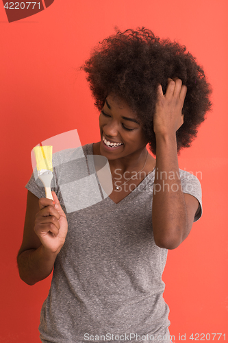 Image of black woman painting wall