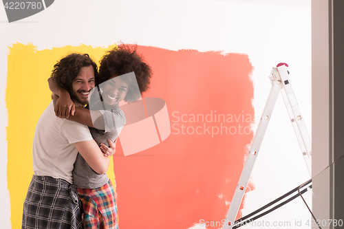 Image of Young happy multiethnic couple hugging