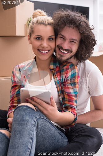 Image of young couple moving  in new house