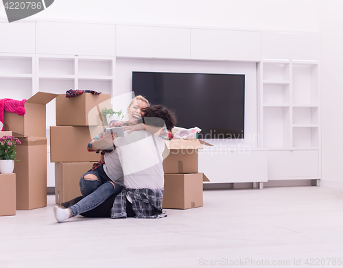 Image of young couple moving  in new house