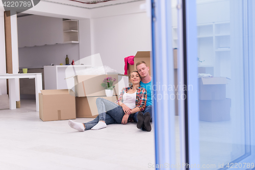 Image of young couple moving  in new house