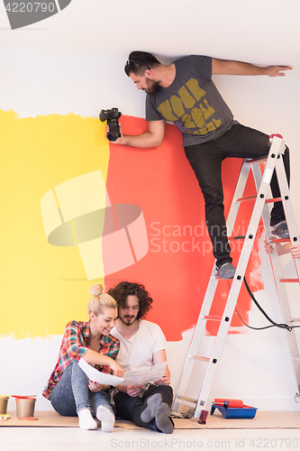 Image of Happy young couple relaxing after painting