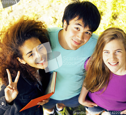 Image of cute group of teenages at the building of university with books 