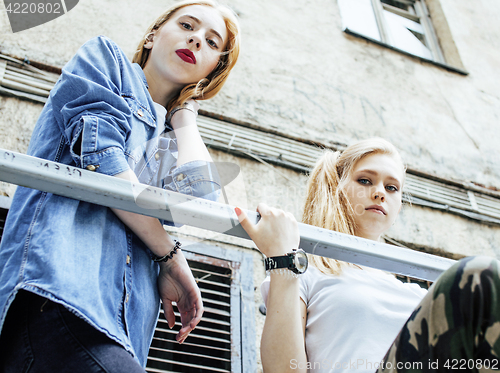 Image of two cool blond real girls friends making selfie on roof top, lif