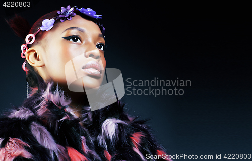 Image of young pretty african american woman in spotted fur coat and flowers jewelry on head smiling sweet etnic make up bright 