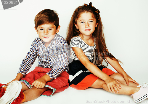 Image of little cute boy and girl hugging playing on white background, ha