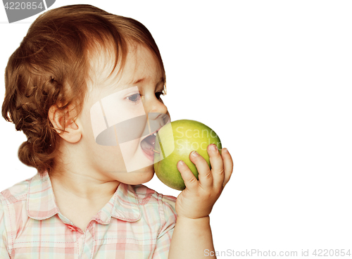 Image of little cute baby girl pointing isolated on white close up with green apple smiling adorable lifestyle