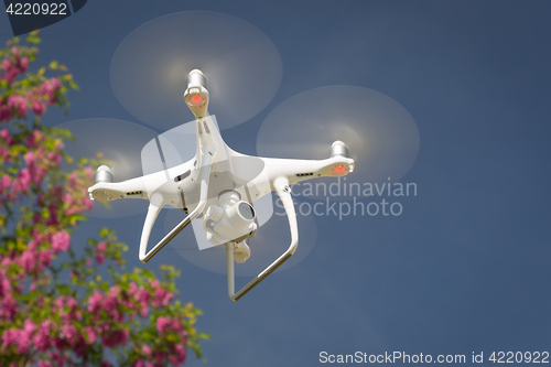 Image of Unmanned Aircraft System (UAV) Quadcopter Drone In The Air.