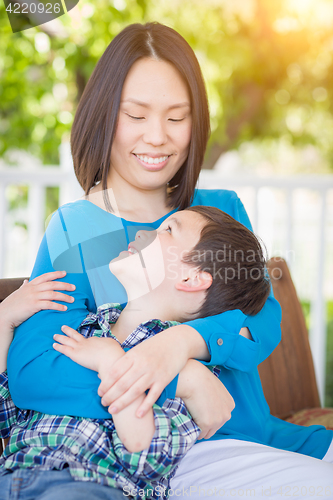 Image of Outdoor Portrait of Chinese Mother with Her Mixed Race Chinese a