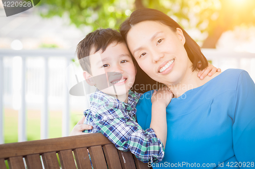 Image of Outdoor Portrait of Chinese Mother with Her Mixed Race Chinese a