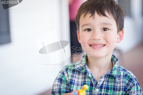 Image of Portrait of Mixed Race Chinese and Caucasian Young Boy With Toy