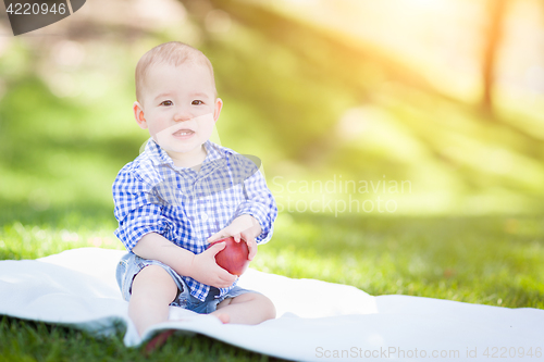 Image of Mixed Race Infant Baby Boy Sitting on Blanket Holding Apple Outs