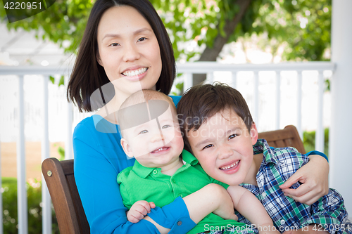 Image of Outdoor Portrait of A Chinese Mother with Her Two Mixed Race Chi