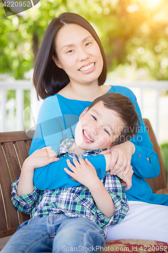 Image of Outdoor Portrait of Chinese Mother with Her Mixed Race Chinese a