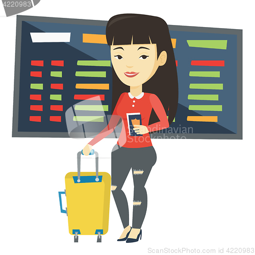 Image of Woman with suitcase and ticket at the airport.