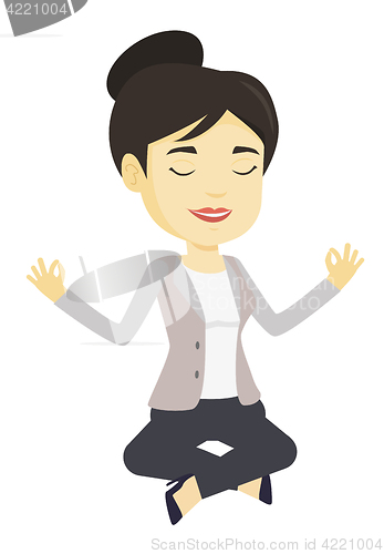 Image of Business woman meditating in lotus position.