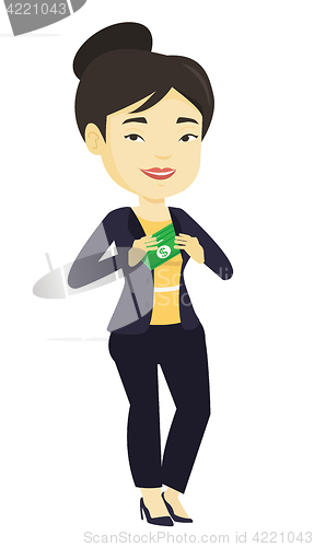 Image of Business woman putting money bribe in pocket.