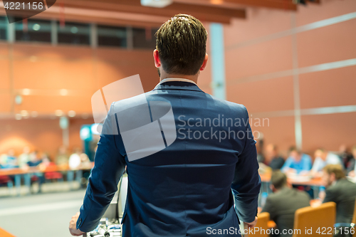 Image of Public speaker giving talk at Business Event.