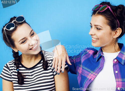 Image of best friends teenage school girls together having fun, posing emotional on blue background, besties happy smiling, lifestyle people concept 