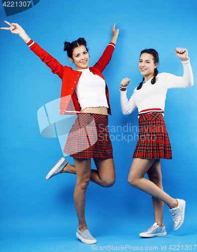 Image of best friends teenage school girls together having fun, posing emotional on blue background, besties happy smiling, lifestyle people concept 