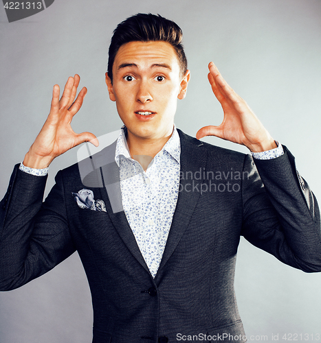 Image of young pretty business man standing on white background, modern hairstyle, posing emotional, lifestyle people concept 