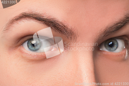 Image of Beautiful blue man eyes close up