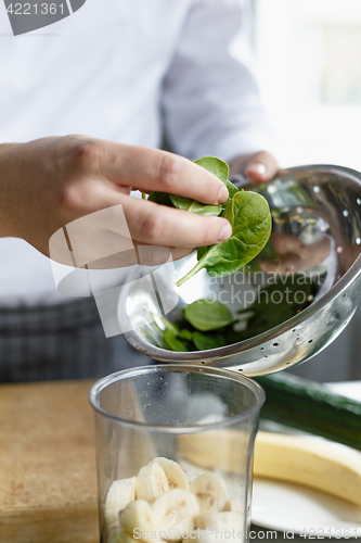 Image of Crop hands making fresh smoothie