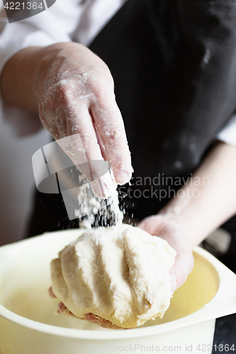 Image of Crop hands making dough