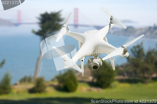 Image of Unmanned Aircraft System (UAV) Quadcopter Drone In The Air Near 