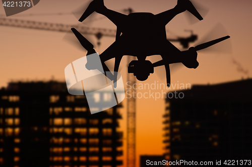 Image of Silhouette of Unmanned Aircraft System (UAV) Quadcopter Drone In