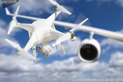 Image of Unmanned Aircraft System (UAV) Quadcopter Drone In The Air Too C
