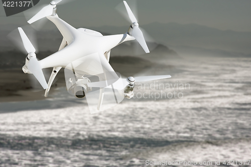 Image of Unmanned Aircraft System (UAV) Quadcopter Drone In The Air Over 