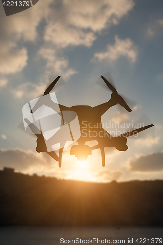 Image of Silhouette of Unmanned Aircraft System (UAV) Quadcopter Drone In