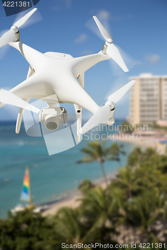 Image of Unmanned Aircraft System (UAV) Quadcopter Drone In The Air Over 