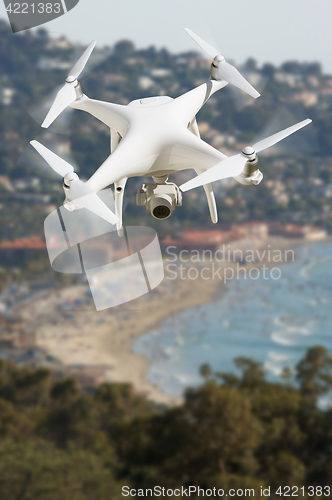 Image of Unmanned Aircraft System (UAV) Quadcopter Drone In The Air Over 