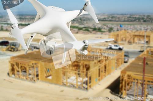 Image of Unmanned Aircraft System (UAV) Quadcopter Drone In The Air Over 