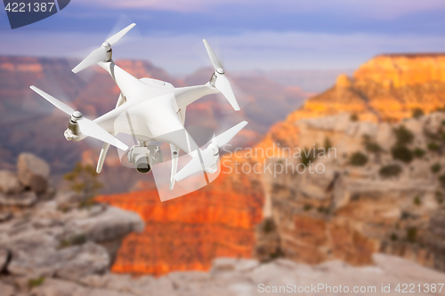 Image of Unmanned Aircraft System (UAV) Quadcopter Drone In The Air Over 