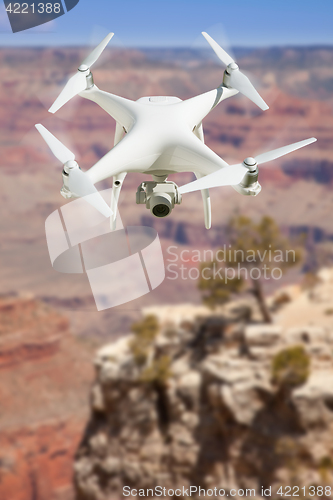 Image of Unmanned Aircraft System (UAV) Quadcopter Drone In The Air Over 