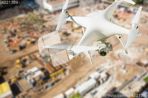 Image of Unmanned Aircraft System (UAV) Quadcopter Drone In The Air Over 