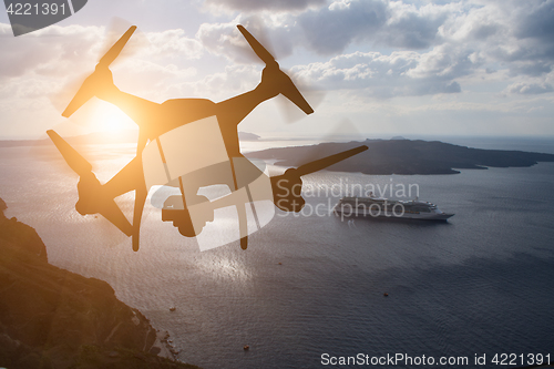 Image of Unmanned Aircraft System (UAV) Quadcopter Drone In The Air At Su