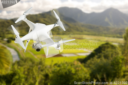 Image of Unmanned Aircraft System (UAV) Quadcopter Drone In The Air Over 