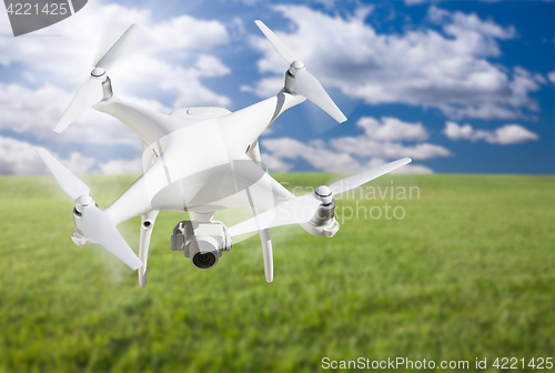 Image of Unmanned Aircraft System (UAV) Quadcopter Drone In The Air Over 