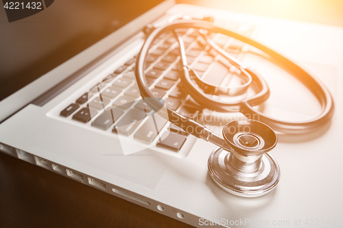 Image of Medical Stethoscope Resting on Laptop Computer Keyboard.