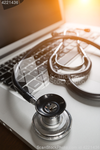 Image of Medical Stethoscope Resting on Laptop Computer Keyboard.